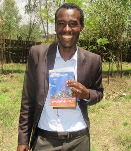 Dereje Joyful With His Study Booklet