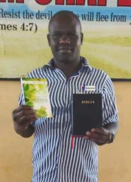 Eric In Prison With His Booklet And Bible