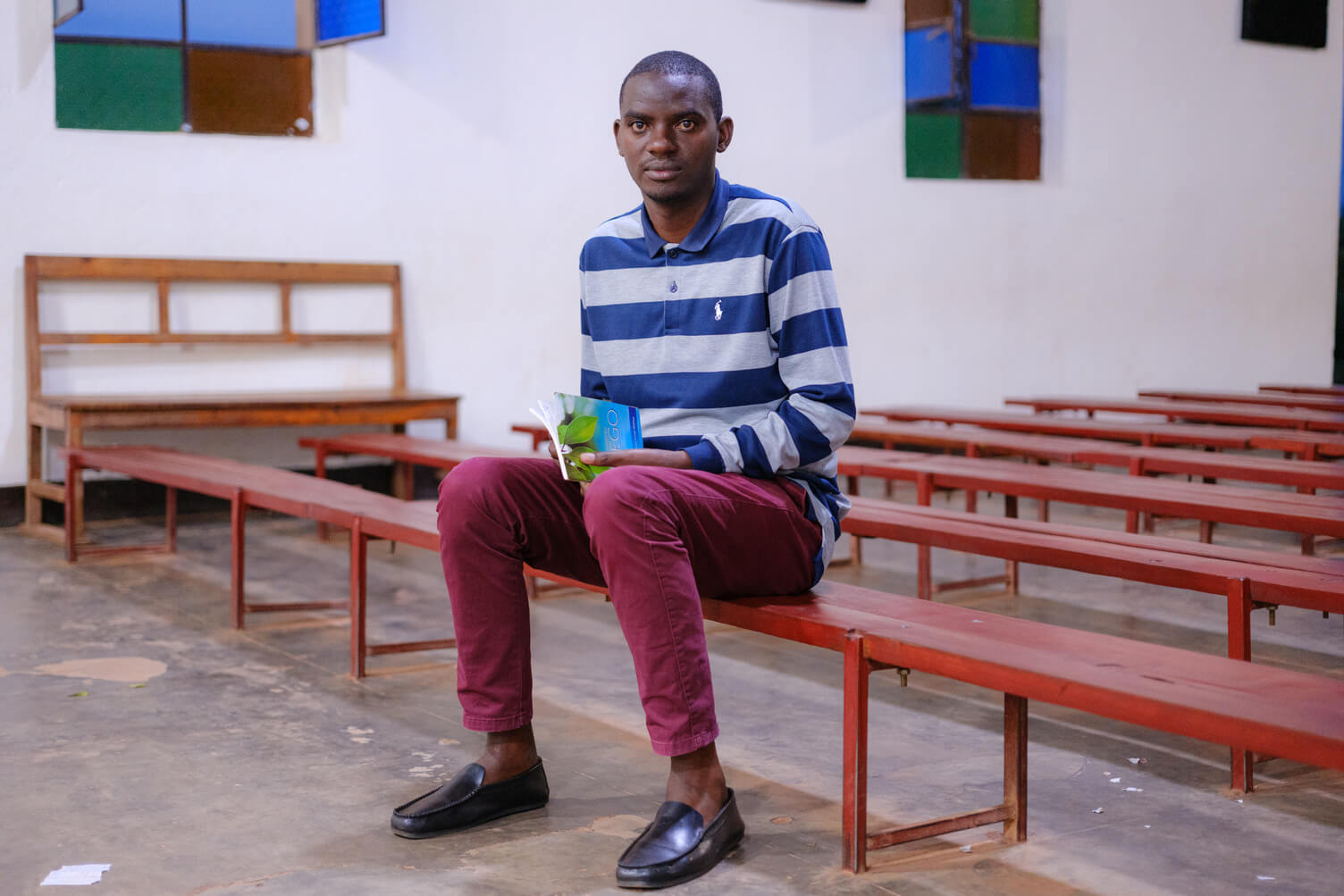 Emmanuel sitting on a bench
